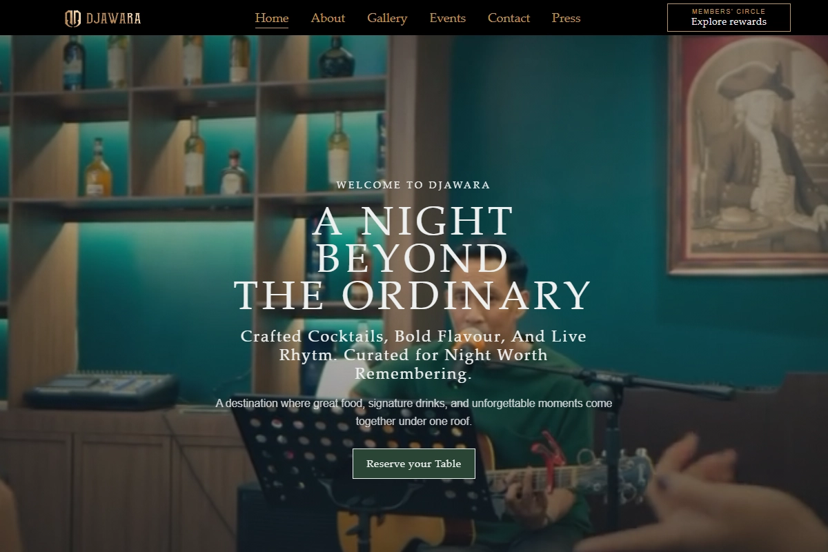 Homepage hero of the djawara.id landing page: the headline “A Night Beyond The Ordinary” over a warmly lit dining-room scene from the site’s background video.
